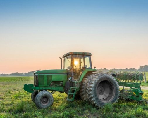 Tractor sitting in filed to demonstrate agriculture equipment financing