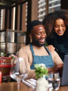 Small business owners using laptop to apply for a restaurant loan