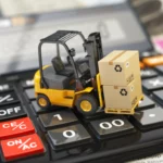 Forklift with cardboxes on calculator. Calculation of shipping delivery costs concept