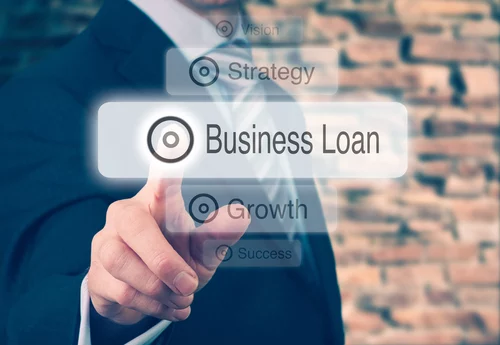 Businessman pressing a Business Loan concept button