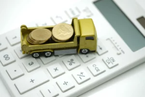 The gold truck full with coins on white calculator use as business and financial concept.