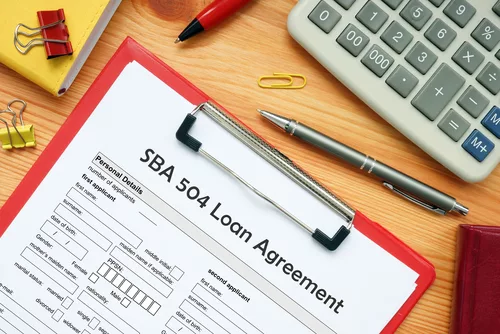 Business concept meaning SBA 504 Loan Agreement with sign on the bank form