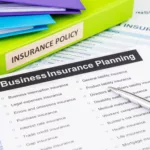 Business insurance planning checklist with documents and binders