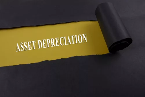 Accounting and finance concept, word asset depreciation on torn paper