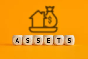 The word assets written on wooden cubes with assets icon on yellow background