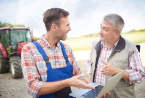 Modern farmers over the laptop heavy equipment loan
