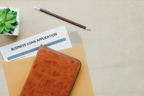 The business loan application form pencil letter and diary tree on wooden table background