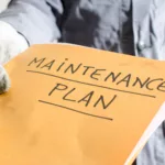Worker holding a folder of maintenance plan,
